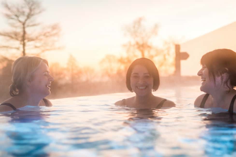 Guests laughing in rooftop pool at Ragdale Hall