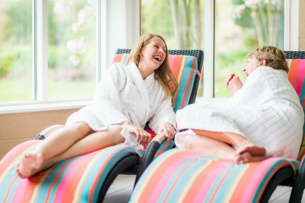 Guests laughing on loungers during weekend spa break