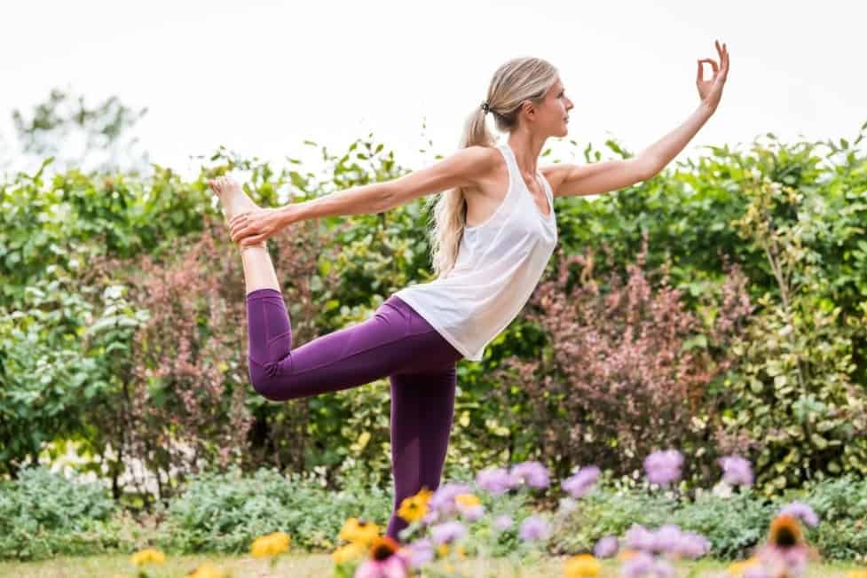 Guest doing yoga outside at Ragdale Hall