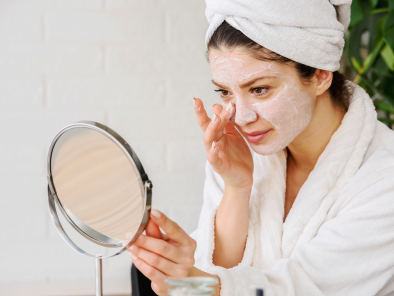 Young woman applying face mask at home. Natural Skin Care Routin